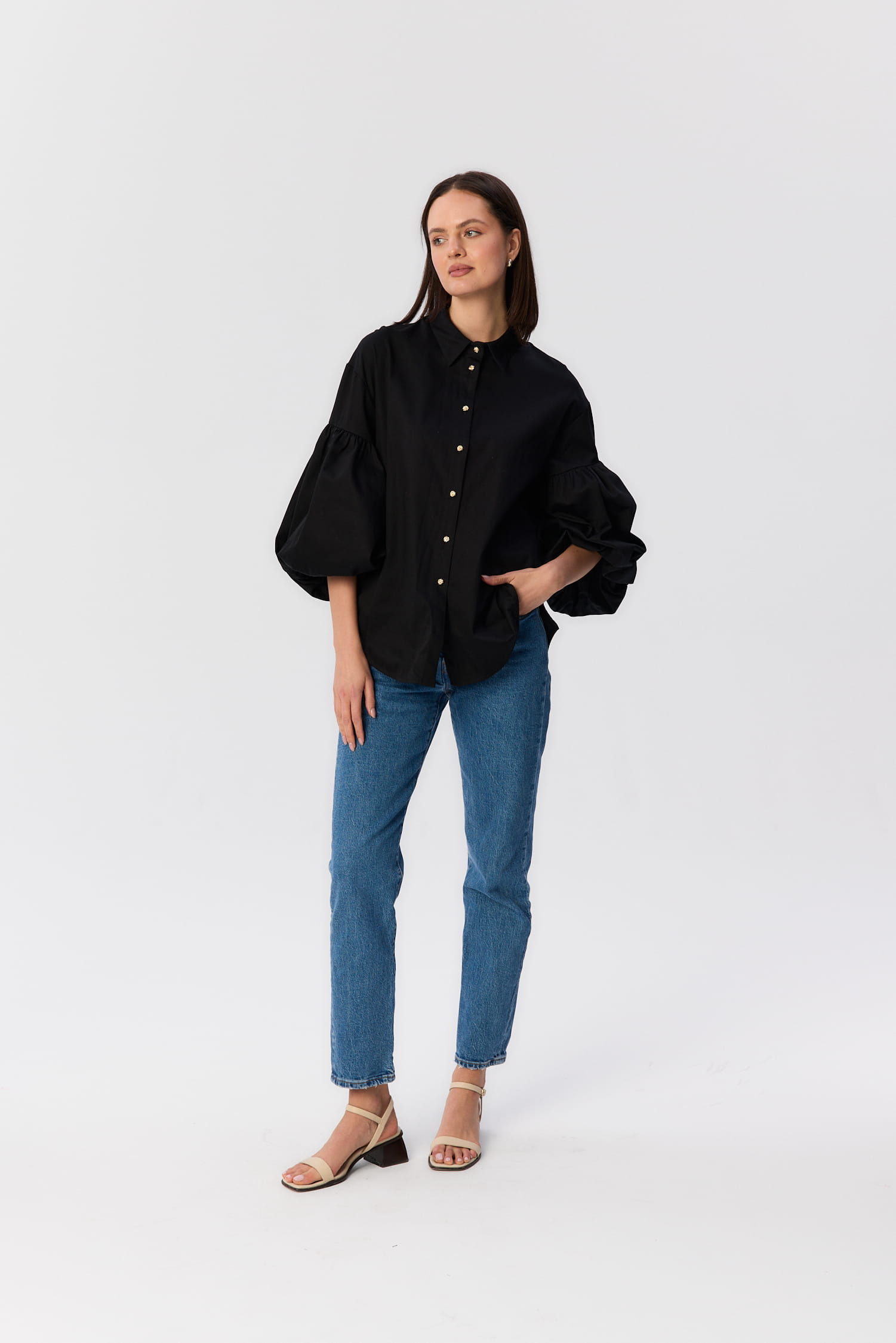 Czarna koszula Lisi MAG NOLLY z bufkami i złotymi guziczkami, stylizacja z dżinsami, widok z przodu.